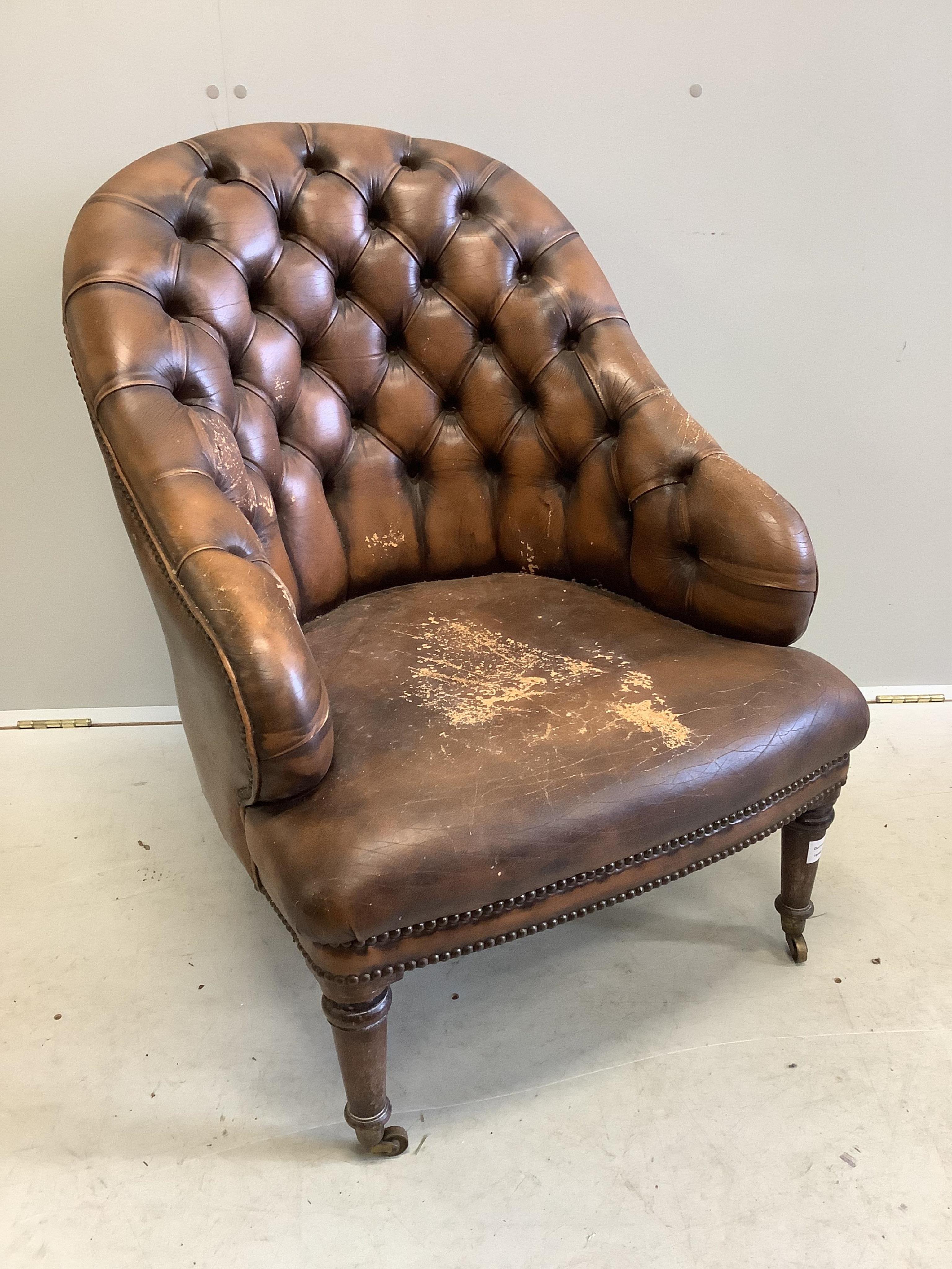 A Victorian style buttoned brown leather tub framed library chair, width 64cm, depth 74cm, height 80cm. Condition - fair, seat poor